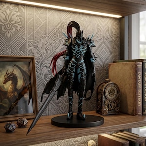 May include: A detailed figurine of a warrior in black armor with teal accents, a flowing black cape, and a long sword. The figure stands on a black base. The background includes a framed dragon painting, books, and a decorative clock, suggesting a fantasy theme.
