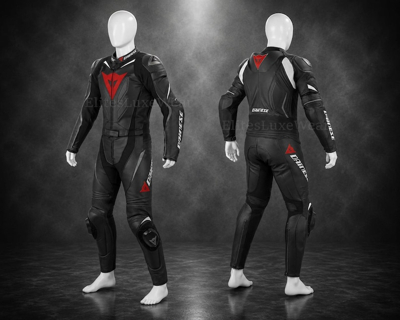 May include: Black and red motorcycle racing suit with white detailing. The suit has a red triangle logo on the chest and leg, with the brand name in white on the sleeves. The suit is displayed on a mannequin.
