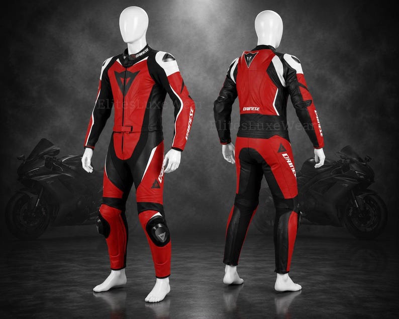 May include: A red, black, and white motorcycle racing suit. The suit is displayed on a mannequin, showcasing the front and back views. The suit features a high collar, elbow and knee protection, and the brand name "Dainese". The suit is designed for motorcycle racing.