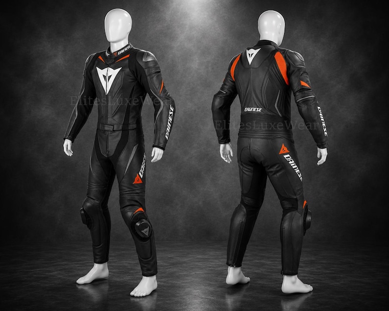 May include: Black and orange motorcycle racing suit with white detailing. The suit has a white logo on the chest and the word "DAINESE" in white on the sleeves and legs. Designed for protection and speed, it's a one-piece suit.