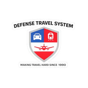 May include: A white sticker with the text "DEFENSE TRAVEL SYSTEM" in a curved font above a shield design. The shield is divided into blue and red sections, with car, train, and airplane icons. The text "MAKING TRAVEL HARD SINCE 1990" is below.