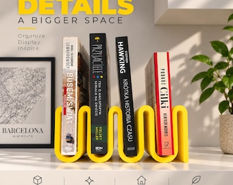 May include: A bright yellow, wavy-shaped book rack holding four books upright. The text "SMALL DETAILS A BIGGER SPACE" appears at the top, with "Organize. Display. Inspire." below it. Four icons with labels "STABLE SUPPORT," "STYLISH DESIGN," "FITS ANY INTERIOR," and "BRIGHTENS YOUR SPACE" are at the bottom.
