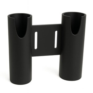 May include: A matte black dual rod holder featuring two cylindrical tubes connected by a central mounting plate. The plate includes two vertical slots for attachment, and each tube has a U-shaped cutout at the top rim for secure placement.