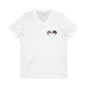 May include: White V-neck t-shirt featuring a small graphic of two skulls facing each other, with purple and gray accents. The shirt is made of a soft, lightweight material, suitable for casual wear.