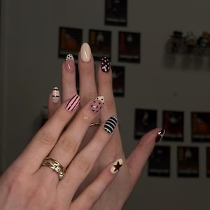 Press-on nails with striped and polka dot patterns