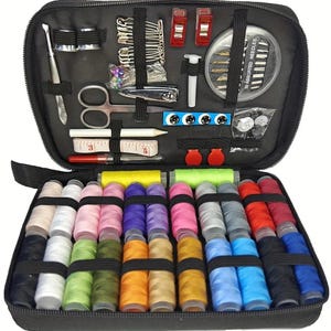 May include: A black zippered sewing kit, open to reveal various sewing tools and supplies. Includes spools of thread in multiple colors, needles, scissors, measuring tape, and other accessories. The kit is designed for convenient storage and portability.