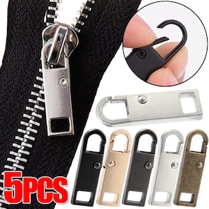 Könnte beinhalten: Nahaufnahme eines schwarzen Reißverschlusses mit silbernem Zipper. Das Bild zeigt auch fünf Ersatz-Reißverschluss-Schieber in verschiedenen Metallausführungen: Schwarz, Gold, Silber und Bronze. Der Text "5PCS" ist rot dargestellt.