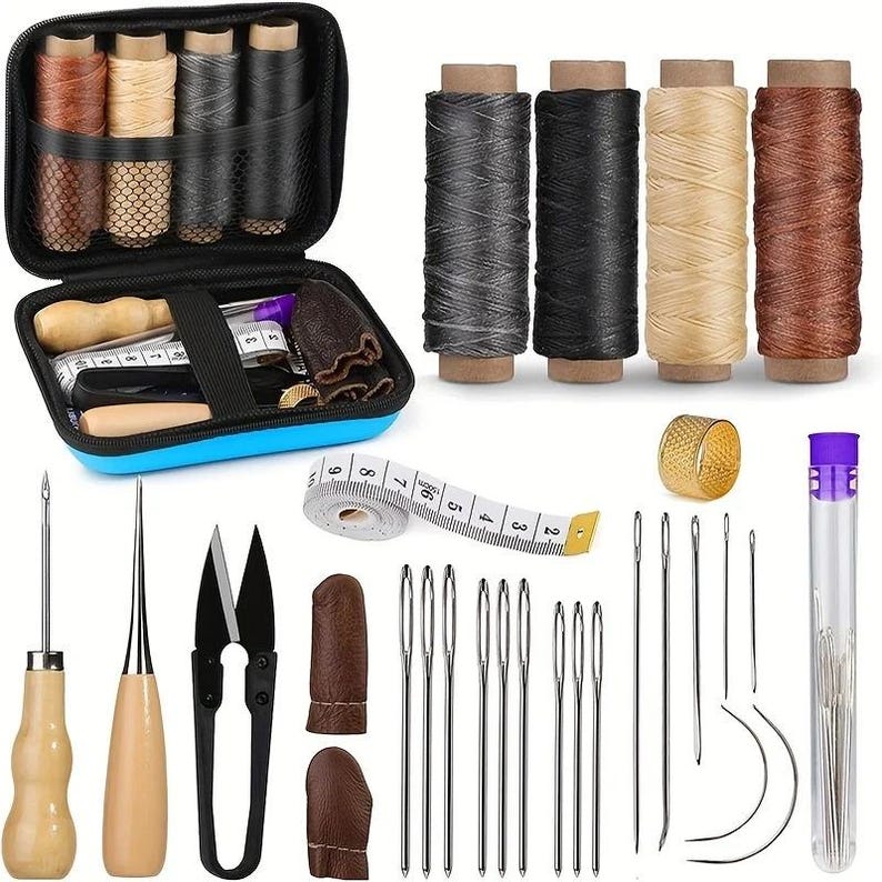 May include: A leathercrafting kit with various tools and supplies. Includes spools of thread in multiple colors, needles, scissors, a thimble, a measuring tape, and other essential tools. The kit is stored in a blue and black zippered case.
