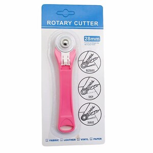 May include: A pink rotary cutter with a 28mm blade, packaged on a blue and white card. The packaging includes diagrams showing different cutting styles. The cutter is designed for fabric, leather, vinyl, and paper.