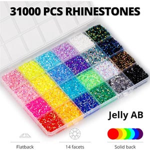 May include: A clear plastic organizer filled with colorful rhinestones. The rhinestones are in various colors, including pink, yellow, blue, and green. The text "31000 PCS RHINESTONES" is at the top, and "Jelly AB" is at the bottom right.