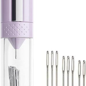 May include: A lavender needle storage case with a clear, cylindrical body, holding a collection of sewing needles. Several loose needles are displayed to the right. The needles are silver and have a small eye.