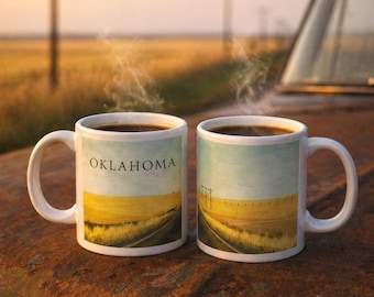 May include: Two white ceramic mugs with a landscape design and the word "OKLAHOMA" on one. The mugs are filled with steaming dark liquid, likely coffee, and sit on a rusty surface.