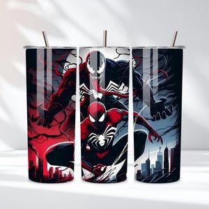 May include: Three stainless steel tumblers with a superhero theme. The tumblers feature illustrations of Spider-Man, Venom, and Carnage against a cityscape backdrop. The color scheme includes red, black, and blue, with silver straws.