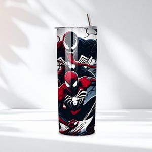 May include: A stainless steel tumbler featuring a vibrant design of Spider-Man, Venom, and their logos. The tumbler has a black, red, and white color scheme, with a silver straw and lid. This insulated tumbler is designed to keep drinks cold or hot.