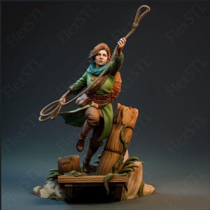 May include: A detailed figurine of a person in a dynamic pose, holding a rope. The figure wears a green tunic, brown pants, and a blue scarf. The base features wooden elements and a rocky terrain, creating a sense of adventure.