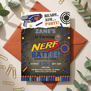 May include: Nerf Battle birthday party invitation featuring a blue and orange Nerf gun, darts, and target graphics. The invitation includes the text "Zane's is Turning 7" and party details.