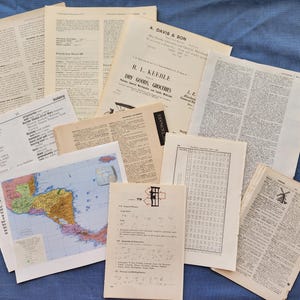 May include: A collection of vintage paper ephemera, including pages with text, a map, and a dictionary page. The papers are aged with a yellowed hue, suggesting their age. Some pages feature printed text and illustrations.