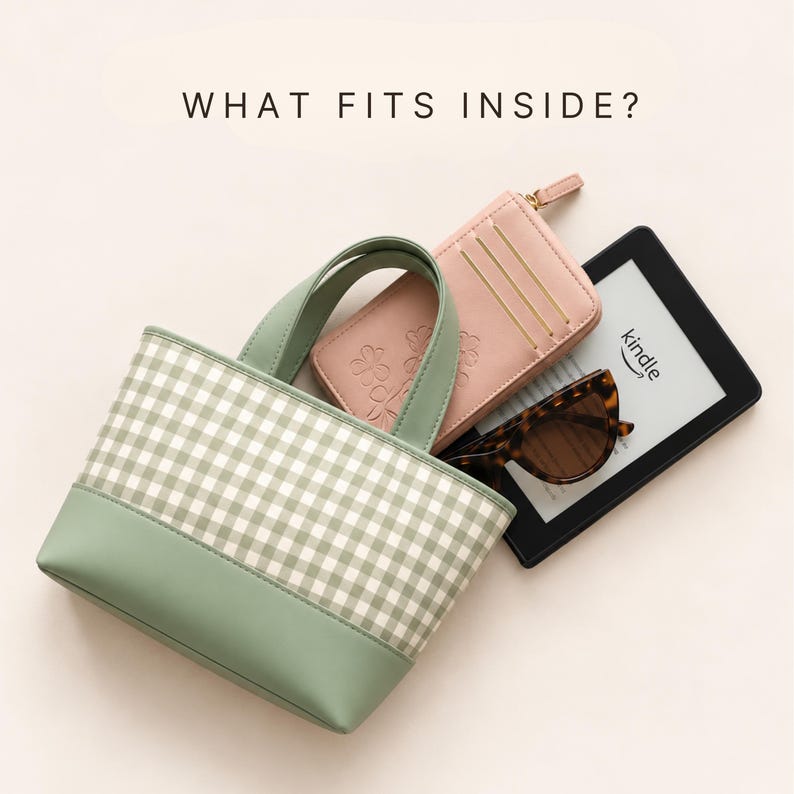 May include: A sage green and white gingham tote bag with a solid sage green base and handles. The bag contains a pink wallet with a floral embossed design, a pair of tortoiseshell sunglasses, and a black Kindle e-reader. Text reads: WHAT FITS INSIDE?