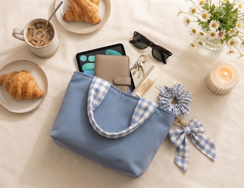 Handmade blue gingham mini bow tote sitting on a table, showing the finished bag made from the beginner-friendly PDF sewing pattern.
