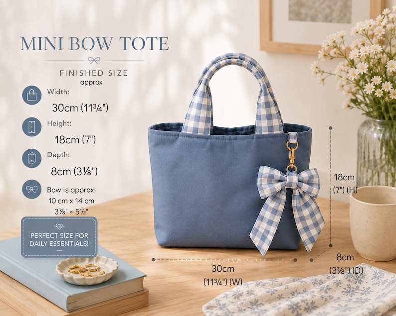 A blue mini bow tote bag with blue and white gingham handles and a matching gingham bow charm. The bag measures 30 cm wide, 18 cm high, and 8 cm deep. The bow measures approximately 10 cm by 14 cm. Text reads MINI BOW TOTE.