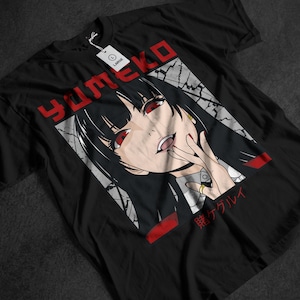 May include: Black t-shirt featuring a graphic of an anime character with red eyes and black hair. The word "Yumeko" is printed in red above the character. Japanese text is below the character. A white tag with the word "LARGE" is attached.