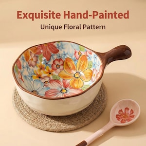 May include: A hand-painted ceramic bowl with a brown handle and a floral pattern in orange, yellow, red, and blue. The bowl sits on a woven coaster, and a matching spoon is next to it. Text on top reads "Exquisite Hand-Painted Unique Floral Pattern."