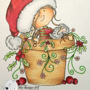 May include: A girl wearing a red and white Santa hat sits in a brown flower pot with green vines and red berries. A small gray mouse sits next to her. The text "My Besties DT on Facebook Heather" is written below the image.