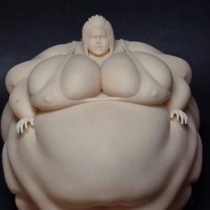 May include: A monochromatic, unpainted resin figurine of a person with a very large, rounded body shape. The figure has a smooth, matte finish, short hair, and is wearing a simple bikini top. The sculpture is presented from a high-angle view.