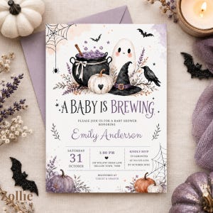 May include: A rectangular baby shower invitation card featuring watercolor illustrations of a black cauldron, a white ghost, a witch hat, pumpkins, a raven, and spiderwebs. The text reads A BABY IS BREWING, honoring Emily Anderson, on Saturday, October 31st at 1:00 PM, with event details including the address, RSVP information, and registry locations.