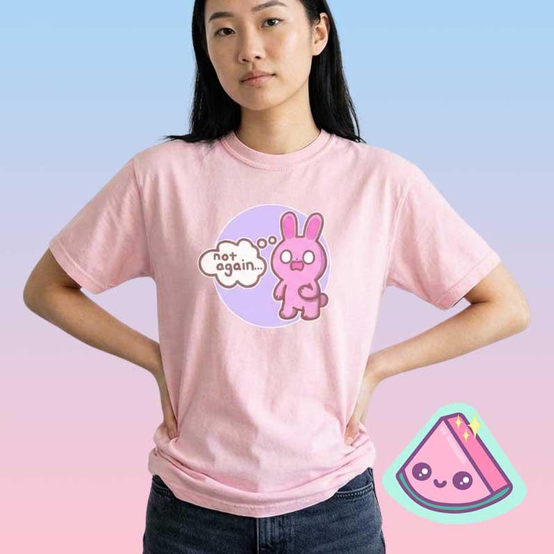 Woman wearing pink funny bunny graphic t-shirt with “not again” text, cute sarcastic pastel mood shirt