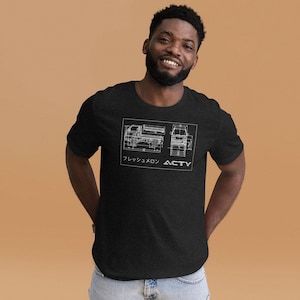 May include: Black t-shirt with a white blueprint design of a small truck. The design includes side and front views of the vehicle, Japanese text and the word "ACTY". The shirt is made of a soft material.