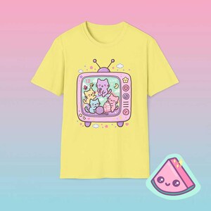Cornsilk yellow retro TV cat shirt featuring dreamy pastel kawaii cats inside vintage television frame.