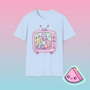 Light blue pastel retro TV cat shirt featuring dreamy kawaii cats inside vintage television frame.