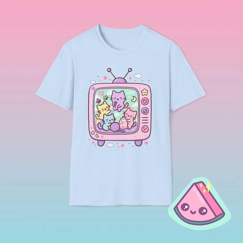 Light blue pastel retro TV cat shirt featuring dreamy kawaii cats inside vintage television frame.