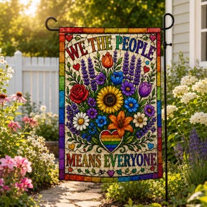May include: A rectangular garden flag featuring a stained glass style design with a rainbow border. The text reads WE THE PEOPLE MEANS EVERYONE. A central bouquet of colorful flowers includes a sunflower, rose, tulips, and a rainbow heart.