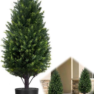 May include: A tall, artificial evergreen tree with dense, green foliage and a dark brown trunk. The tree is potted in a black, cylindrical pot. Two smaller versions of the tree are also shown, placed outside a home, in black pots.