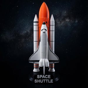May include: A detailed model of a space shuttle, with a white orbiter, orange external tank, and white solid rocket boosters. The model is mounted on a black base with the words "SPACE SHUTTLE" in white. The background is a dark starry sky.