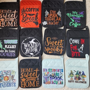 May include: Set of 10 Halloween-themed oven mitts. The mitts are black, red, and blue with various designs and text, including "Home Sweet Haunted Home", "Coffin Break", "One Spook Tacular Teacher", "My Broomstick Runs On Coffee", "Witch Please! Bake Me Some Cookies", "Home of the Wicked Witch", "Sweet and Spooky", "Come In For A Bite", "I Teach The Most Spook Tacular Students", and "Happy Halloween".