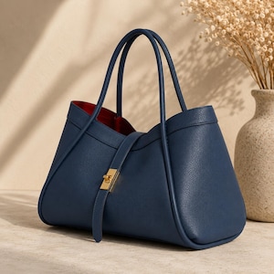 Elegant everyday leather tote purse with gold hardware and spacious interior photographed in luxury setup.