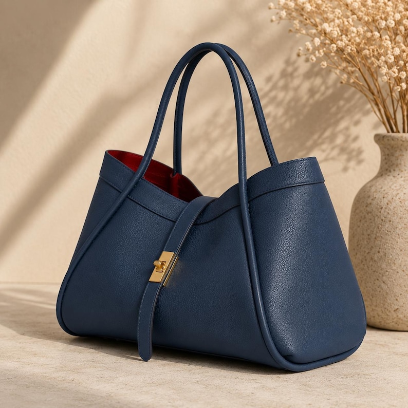 Elegant everyday leather tote purse with gold hardware and spacious interior photographed in luxury setup.