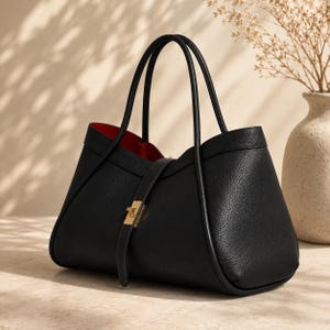 Luxury calf leather tote bag with elegant curved silhouette and soft pebbled leather texture for women.