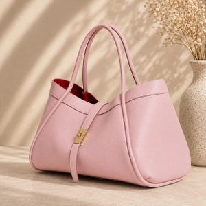Soft genuine leather tote bag for women styled with neutral luxury background and elegant lighting.