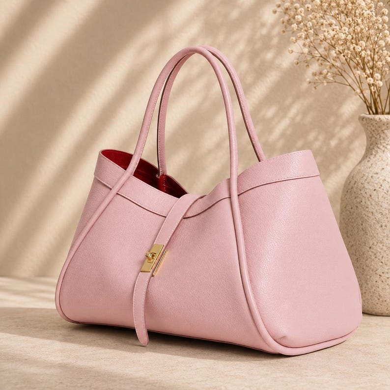 Soft genuine leather tote bag for women styled with neutral luxury background and elegant lighting.