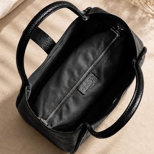Premium women leather handbag with minimalist designer inspired style and spacious daily carry interior.