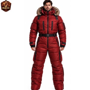 May include: A deep red, insulated, full-body snow suit featuring a hood with a faux fur trim, a black waist belt, multiple zippered pockets on the chest and legs, and black cuffs. The garment has a quilted texture and a front zipper closure.