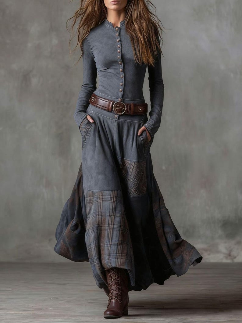 May include: A long-sleeved gray dress with a button-up front and a brown leather belt. The dress features a flowing skirt with plaid patches and is paired with brown lace-up boots. The overall style is bohemian.