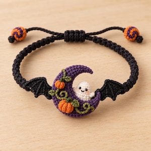 May include: A black macrame bracelet featuring a central purple crescent moon charm adorned with two small orange pumpkins, green vines, and a tiny white ghost. The bracelet has black bat wings on each side and adjustable ends with orange and purple beads.