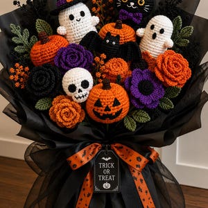 May include: A crochet Halloween bouquet featuring orange pumpkins, a jack-o'-lantern, white ghosts, a black cat, a bat, a skull, and purple and orange flowers. The arrangement is wrapped in black paper with an orange ribbon and a Trick or Treat tag.