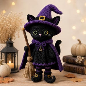 May include: A crocheted black cat doll dressed as a witch, wearing a purple pointed hat with a yellow buckle, a purple cape with a silver star charm, and black boots with yellow buckles. The cat holds a small brown yarn broom in its paw.