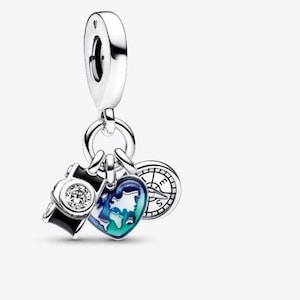 May include: Silver charm with a camera, a heart-shaped world map, and a compass. The camera is black with a clear gem. The heart is blue and green. The compass has black details.